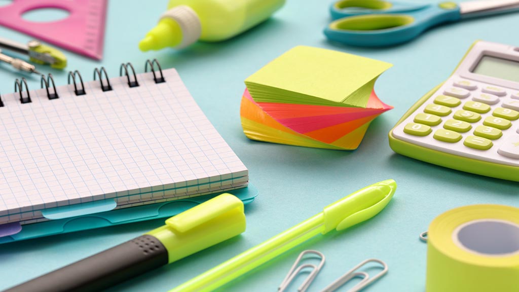 Stationery and office supplies on a blue paper background