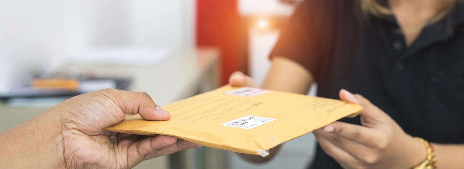 Male hand send mail envelope to the female of post office before